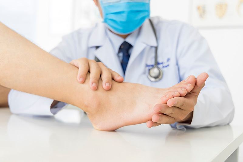 doctor looking at a patient's foot