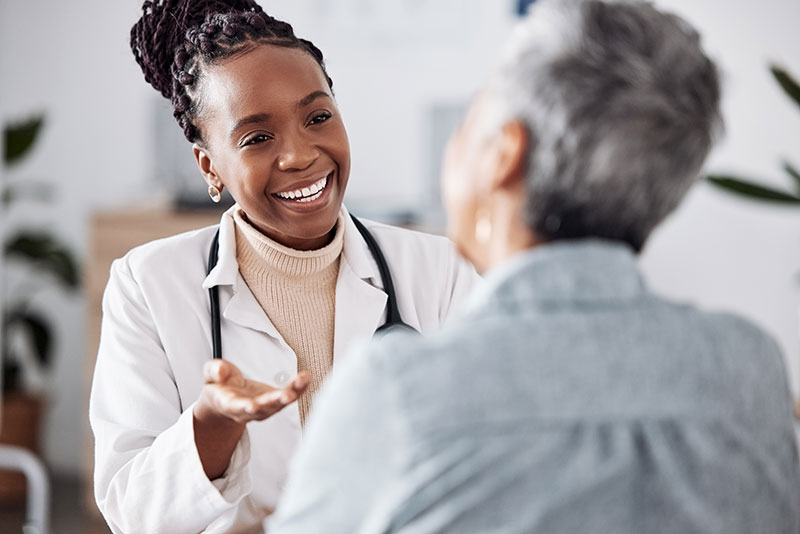 doctor smiling while talking to a patient