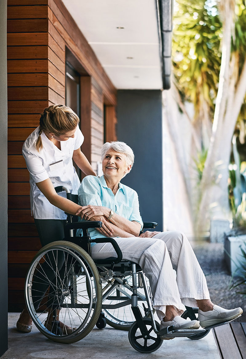 nurse talking to a patient in a wheelchair