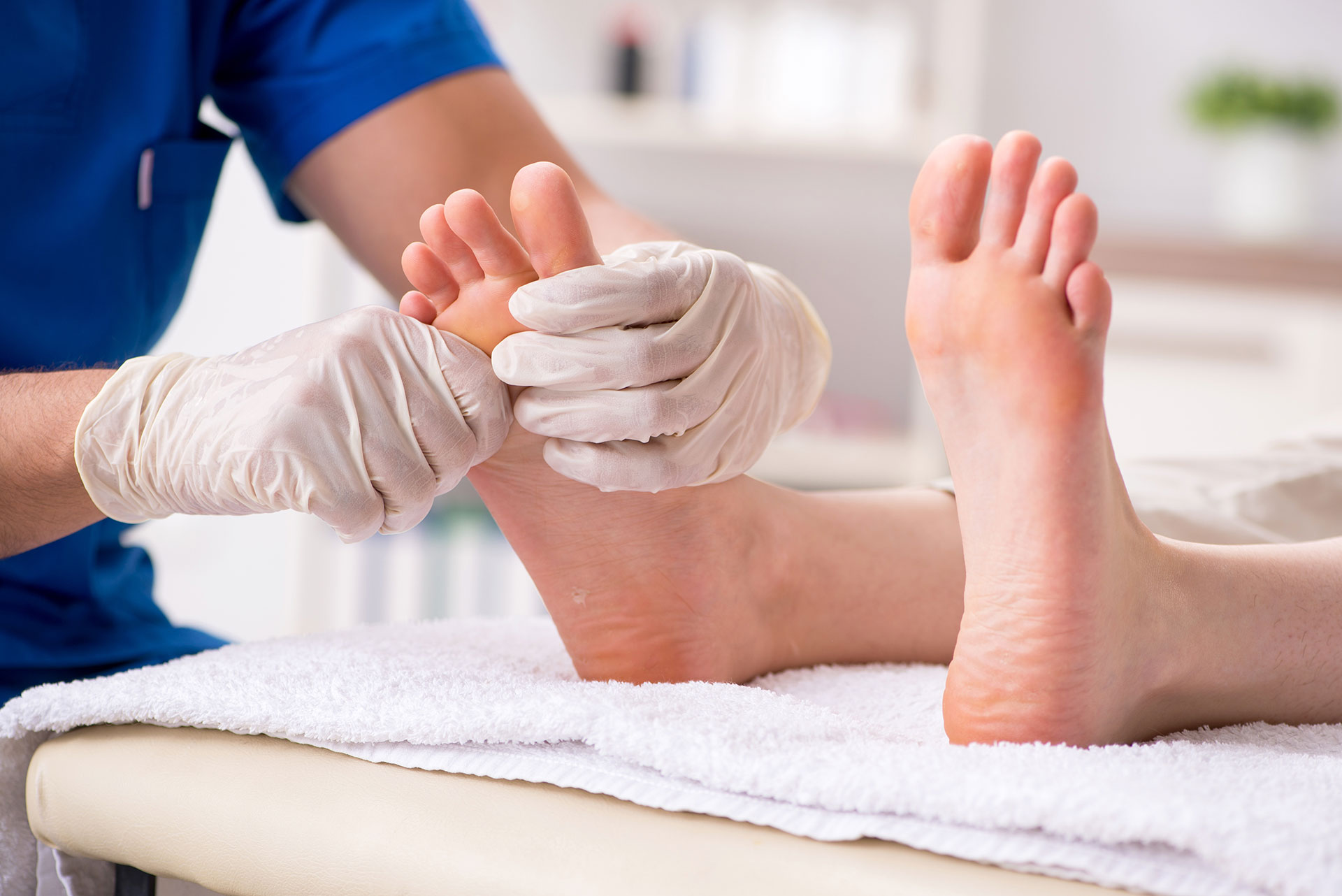 physician assessing a patient's foot