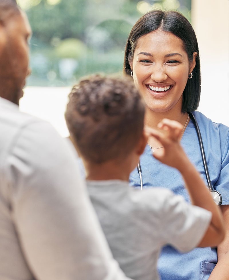 smiling doctor talking to a child patient